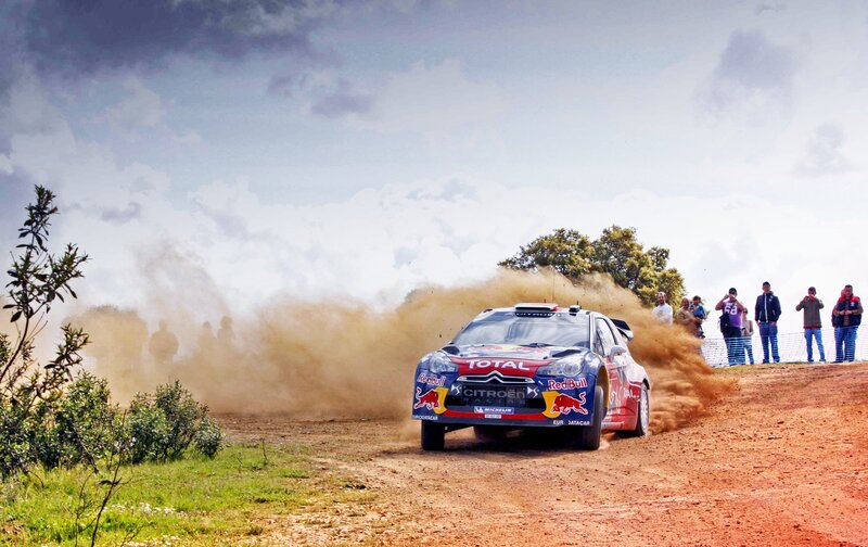 Rally Car on Dirt Road — Brown, Dynamic, Afternoon, Photograph, Dust Cloud, Spectators