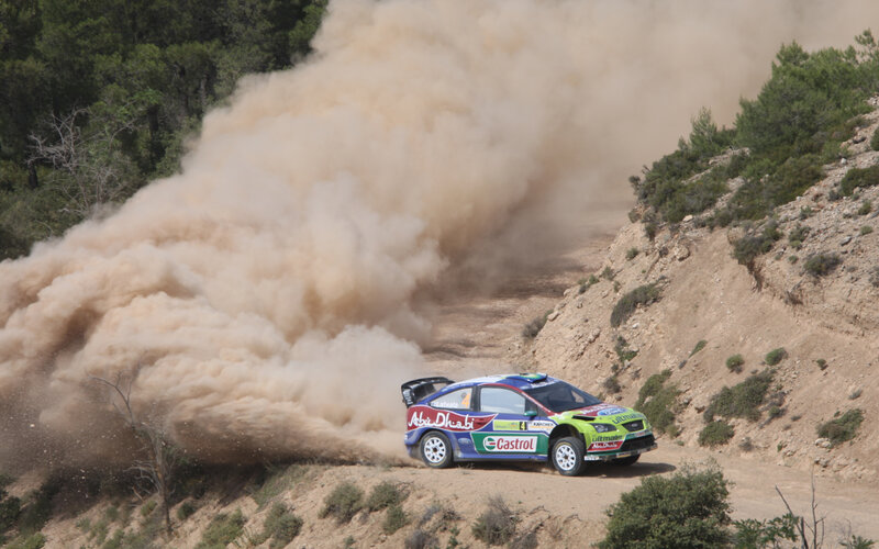 Rally Car on Dirt Road — Brown, Dynamic, Afternoon, Photograph, Dust Cloud, Trees