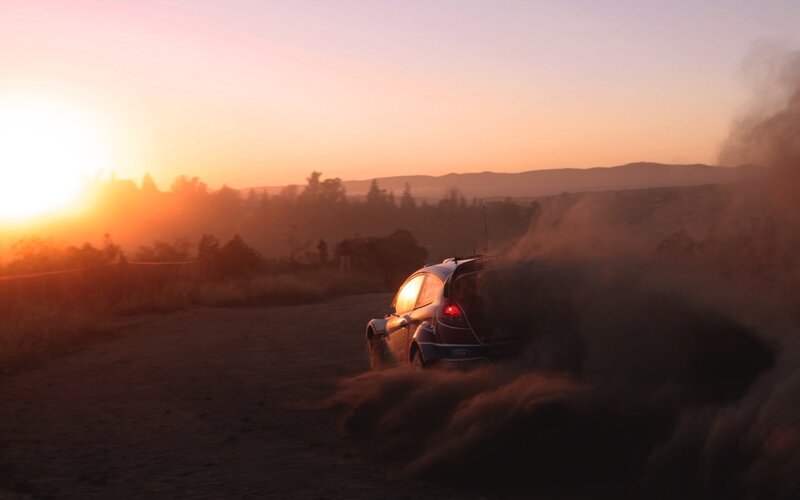 Rally Car on Dirt Road — Orange