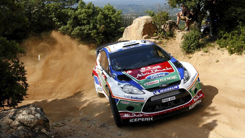 Rally Car on Dirt Road — White, Dynamic, Afternoon, Photograph, Dirt Road, Spectators, Trees, Rocks