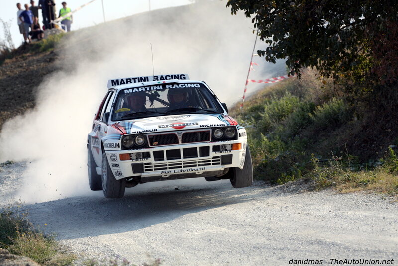 Rally Car on Dirt Road — White, Dynamic, Afternoon, Photograph, Dust Cloud, Spectators