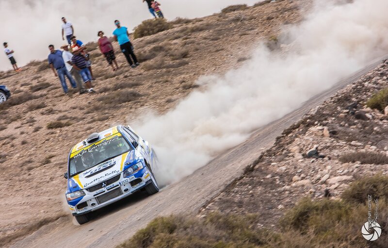 Rally Car on Dirt Road — White, Dynamic, Afternoon, Photograph, Dust