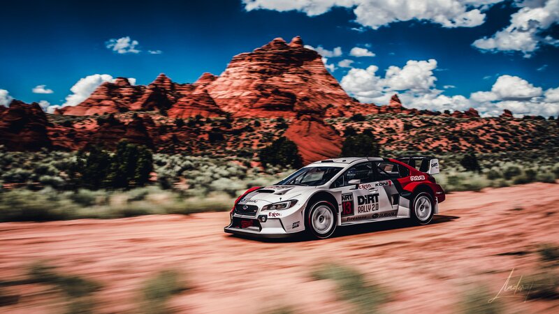 Rally Car on Dirt Road — White, Dynamic, Afternoon, Photograph, Red Rock Formations