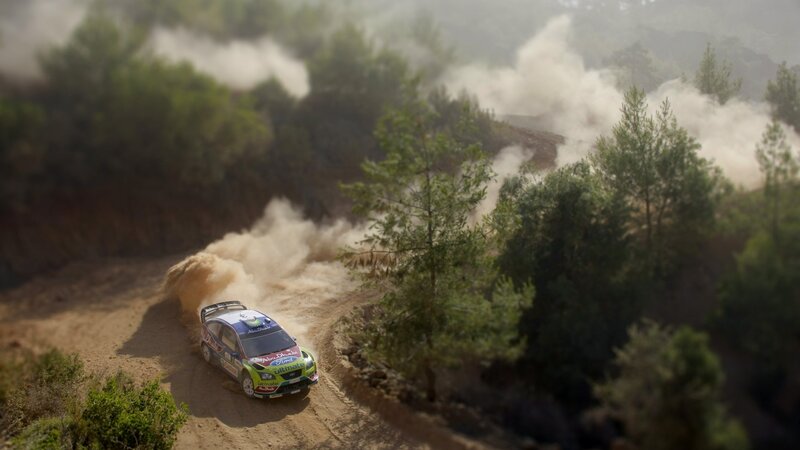 Rally car on dusty forest road