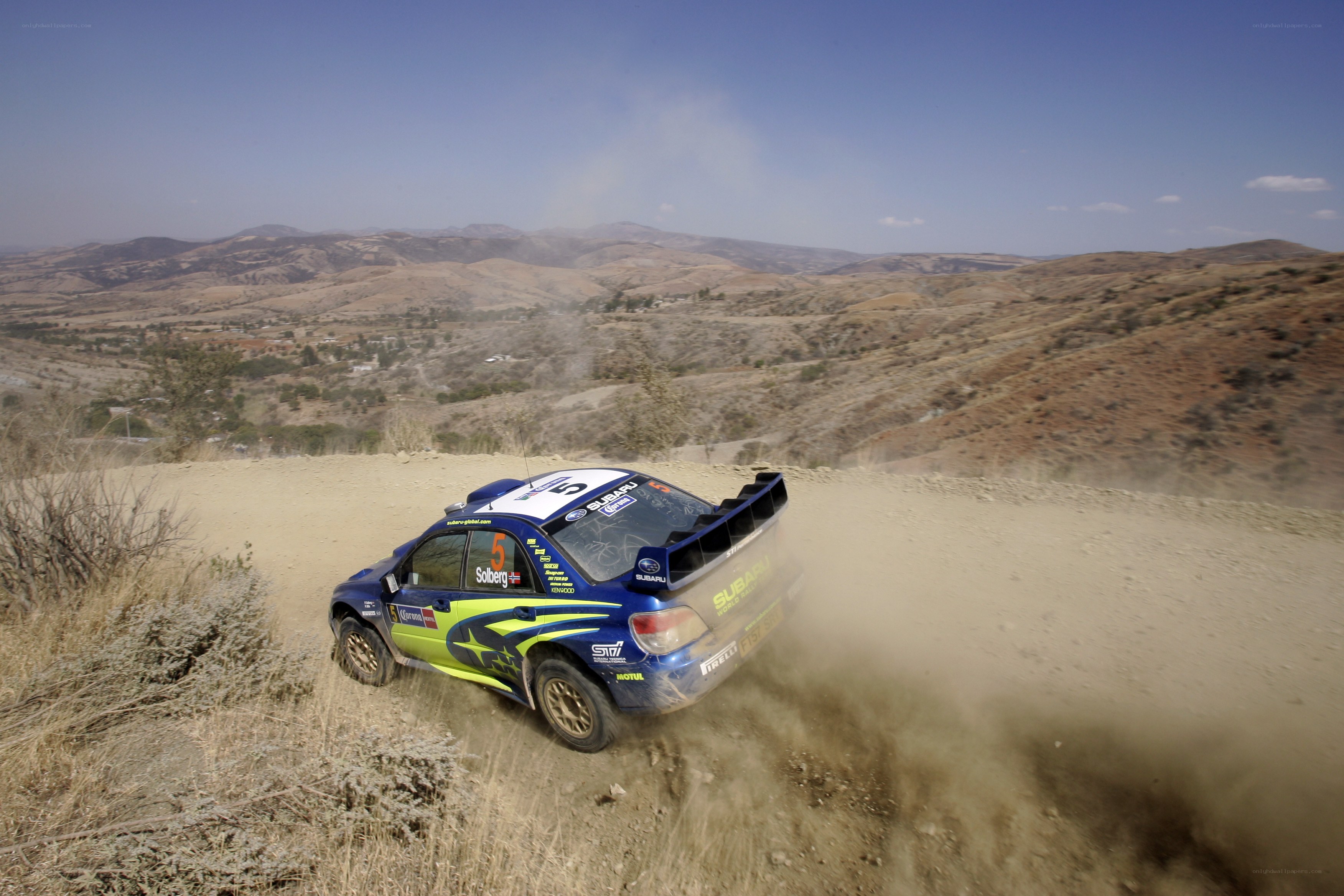 rally car on dusty hill