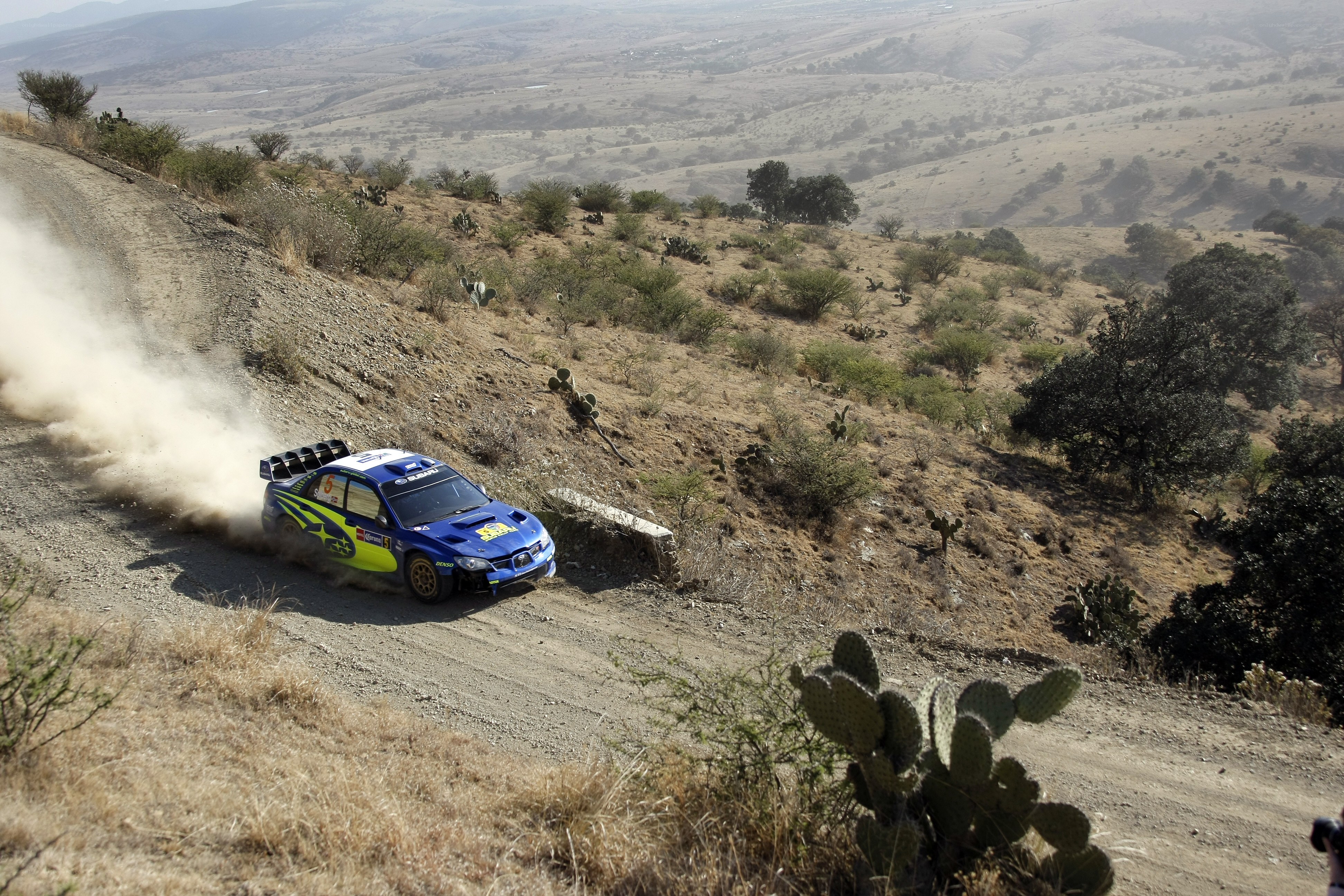 Rally car on dusty hillside