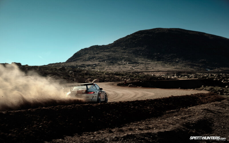 rally car on dusty mountain road