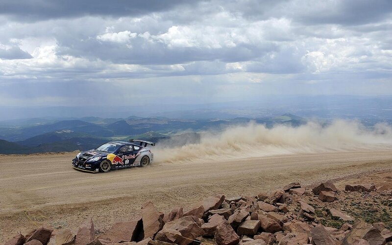 Rally car on dusty mountain road