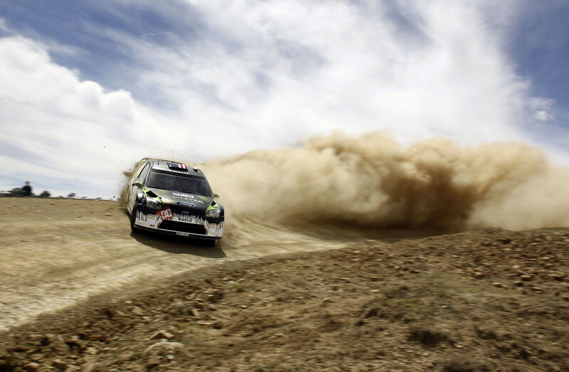 Rally car on dusty track
