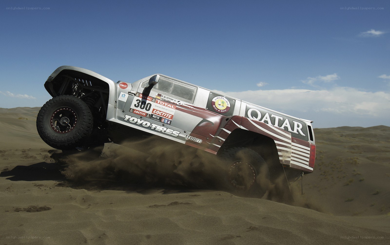 rally car on sand dune