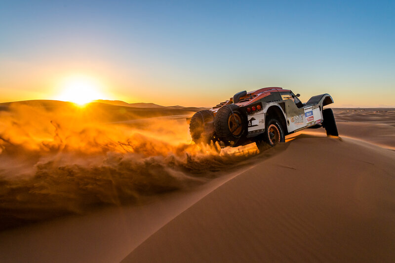 Rally Car on Sand Dune — Orange, Dramatic, Sunset