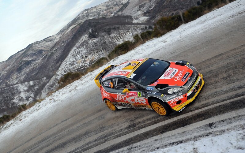 Rally car on snowy mountain road