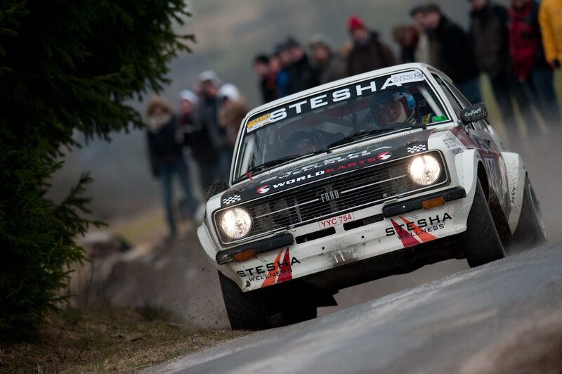 Rally car racing on a wet road