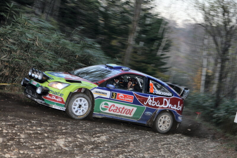 Rally car racing on dirt road