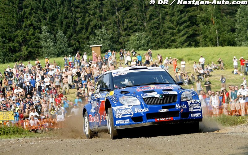 Rally car racing on dirt track