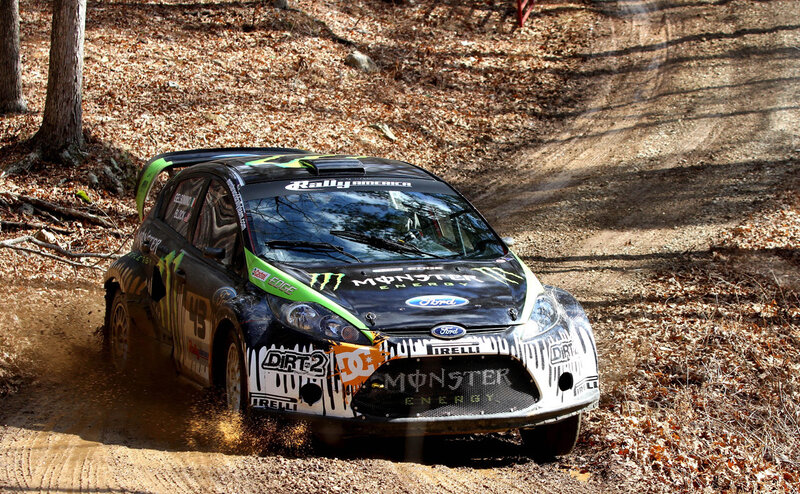 Rally car racing on dirt track