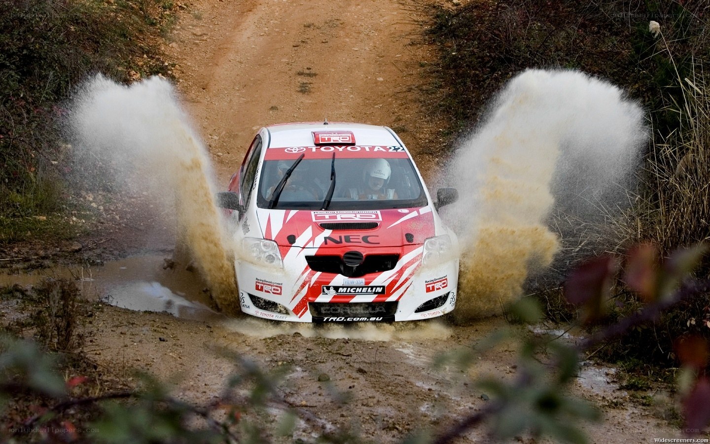rally car splashing mud
