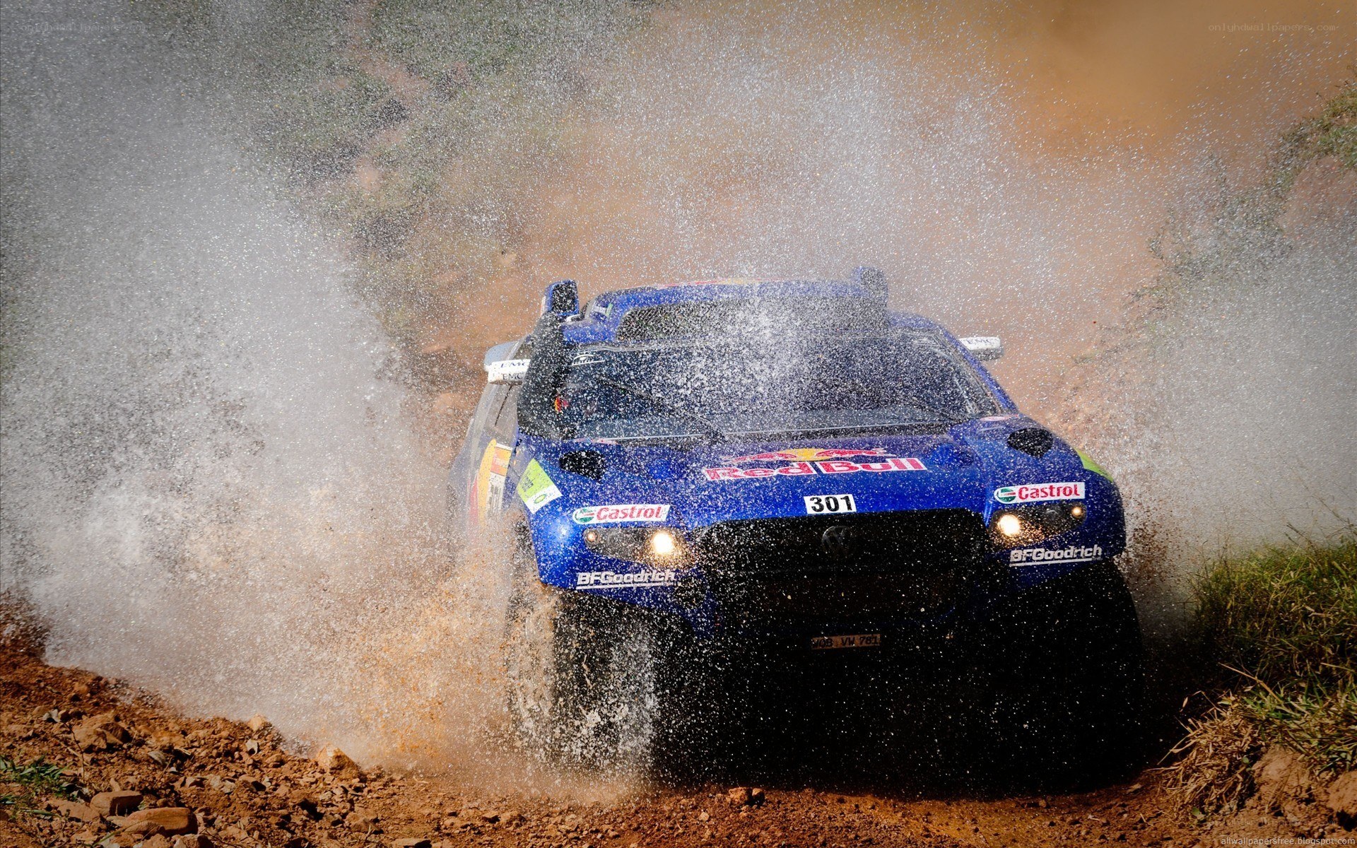 Rally car splashing through mud