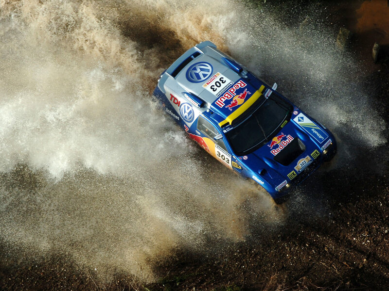rally car splashing through water