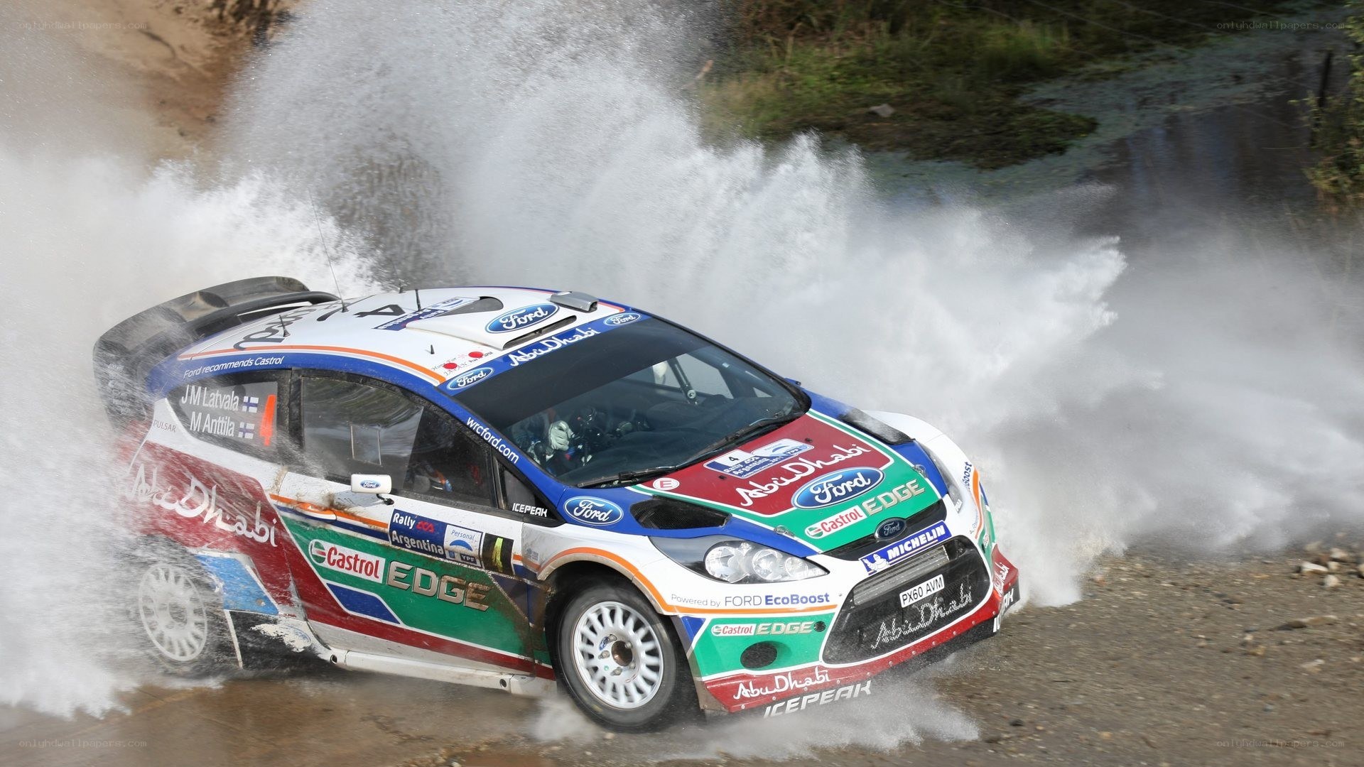 Rally car splashing through water