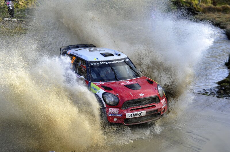 Rally car splashing through water