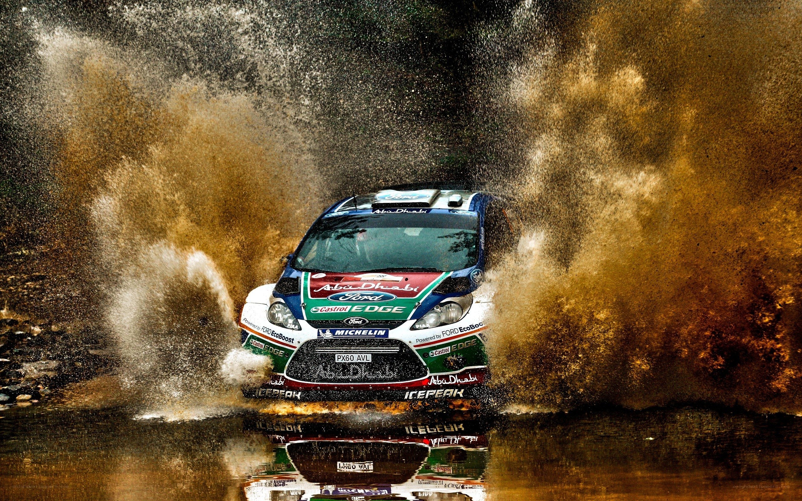 Rally car splashing through water