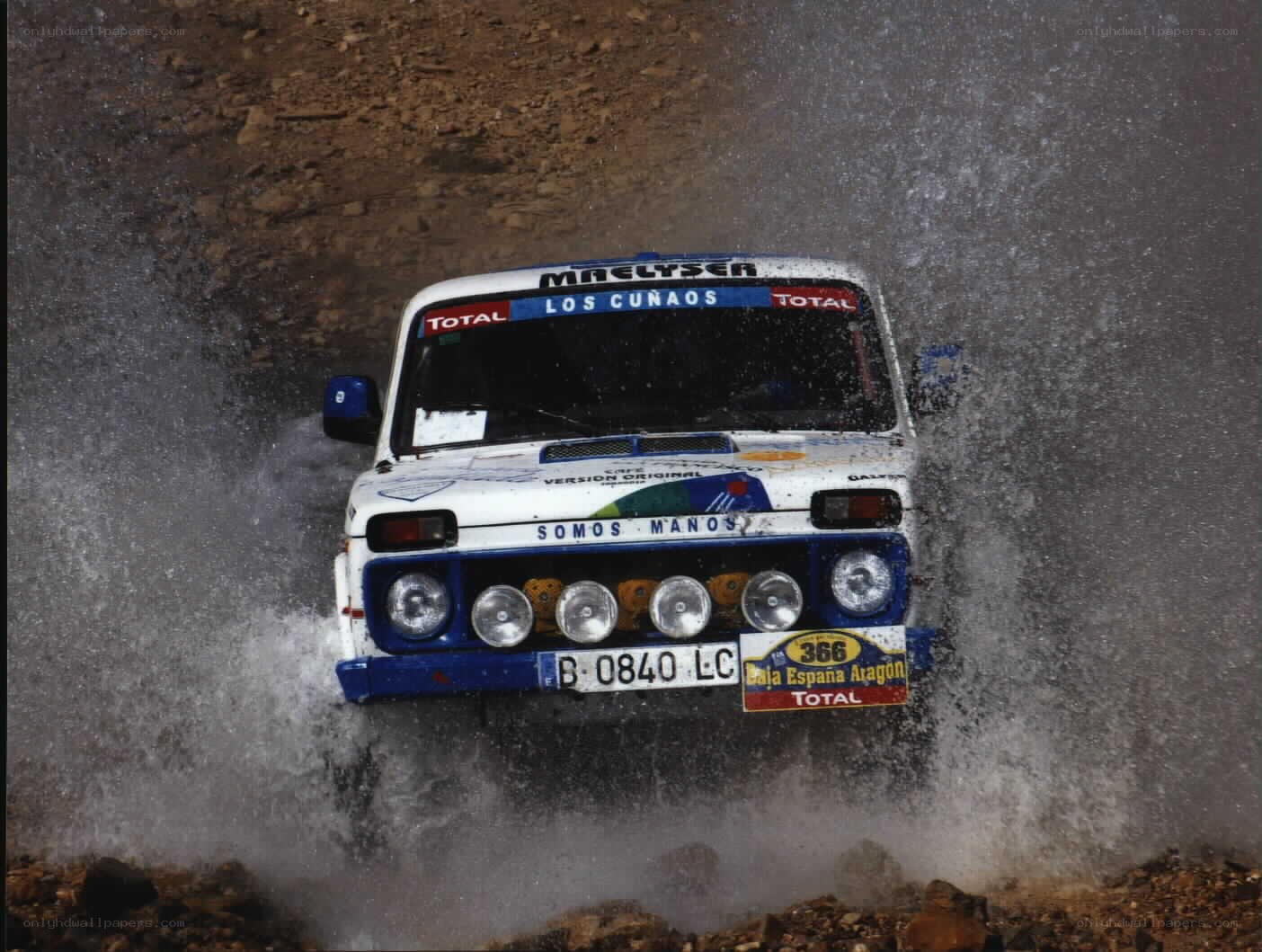 rally car splashing through water