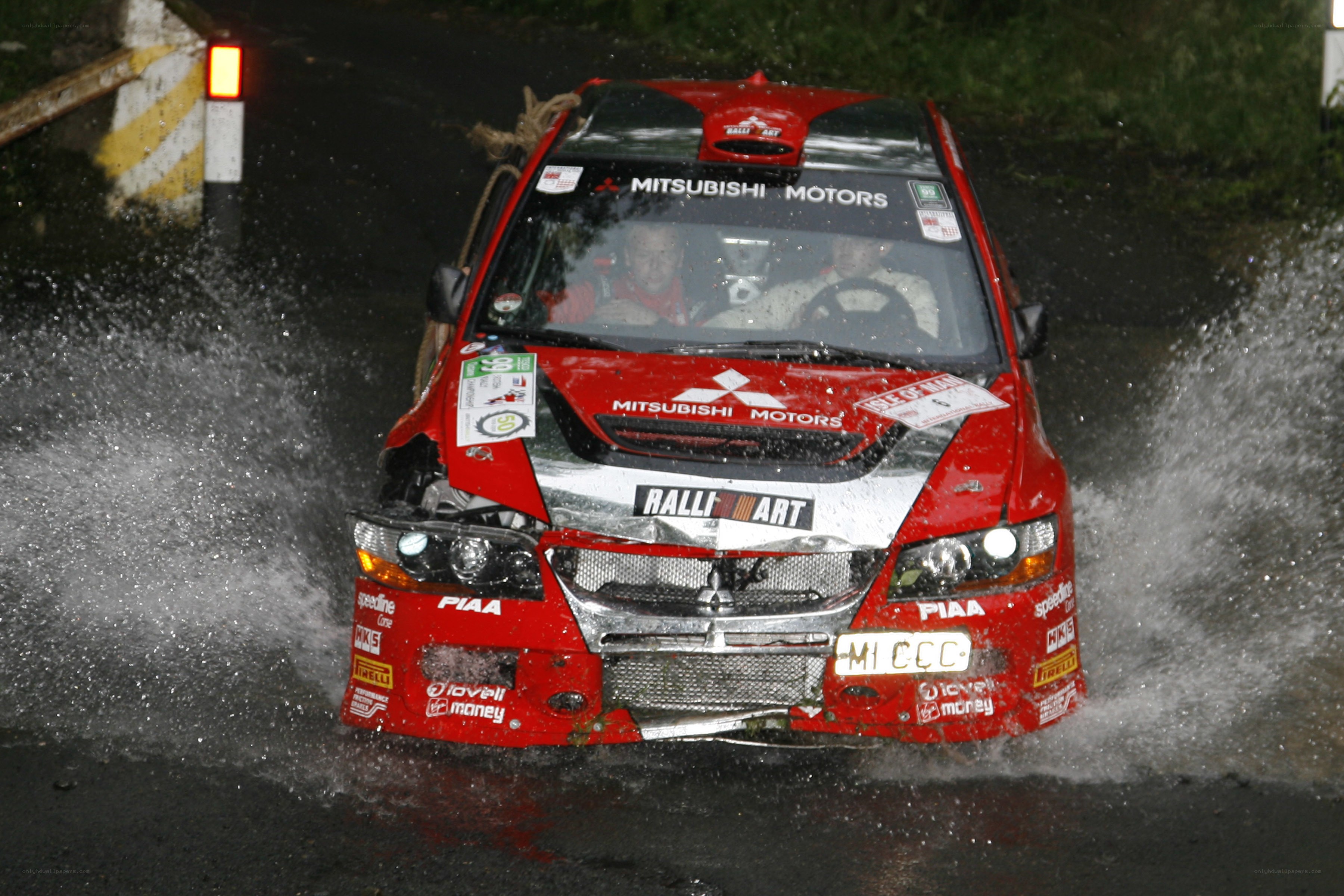 Rally car splashing through water