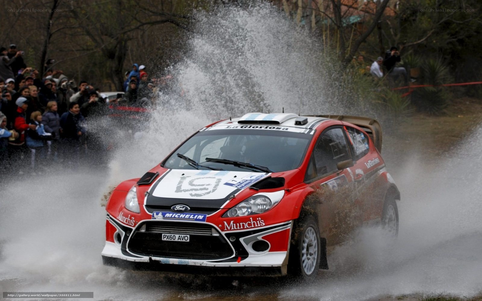 Rally car splashing through water