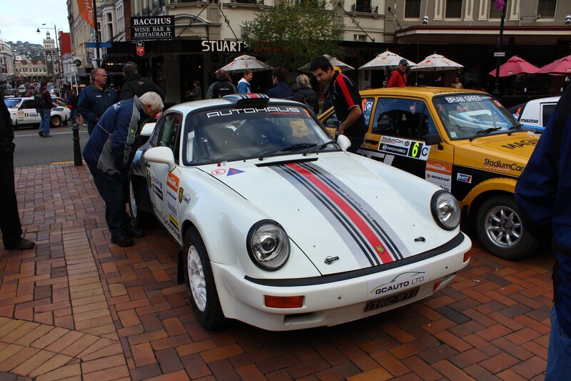 Rally cars on display in a city