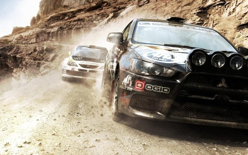 Rally cars racing on dirt road
