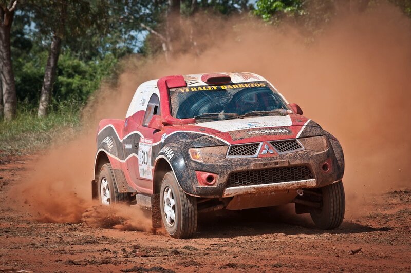 Rally Truck Kicking Up Dust — Red