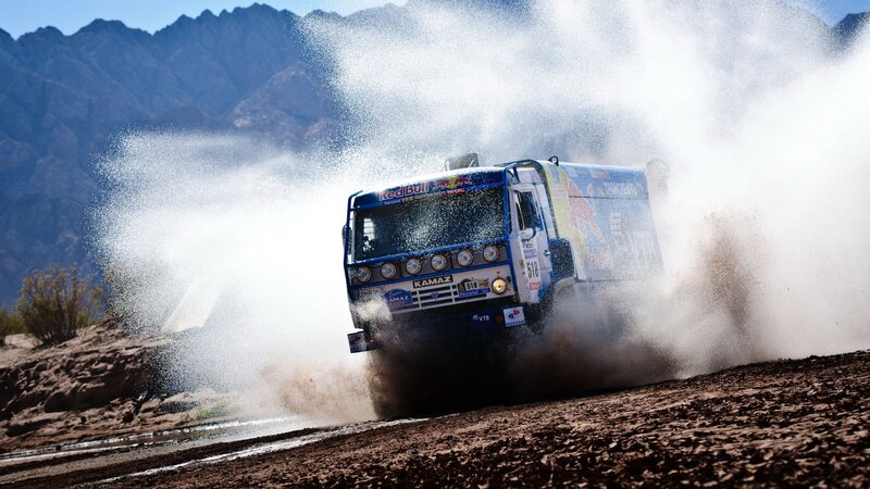 Rally truck splashing through water