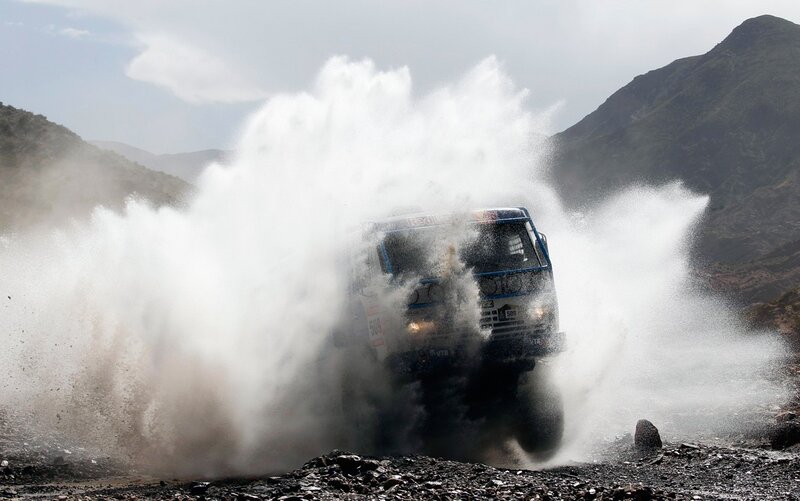 Rally truck splashing through water