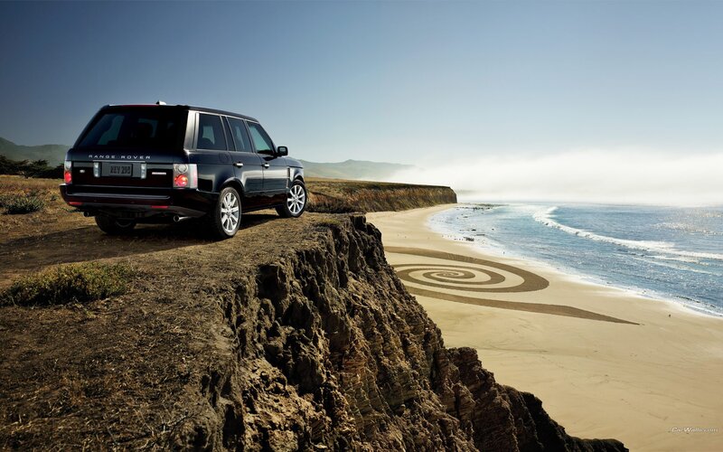 Range Rover on cliff overlooking beach