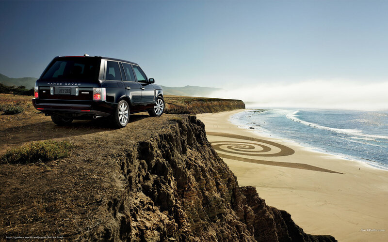 Range Rover on cliff overlooking beach