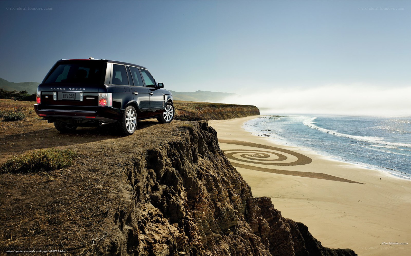 Range Rover on cliff overlooking beach