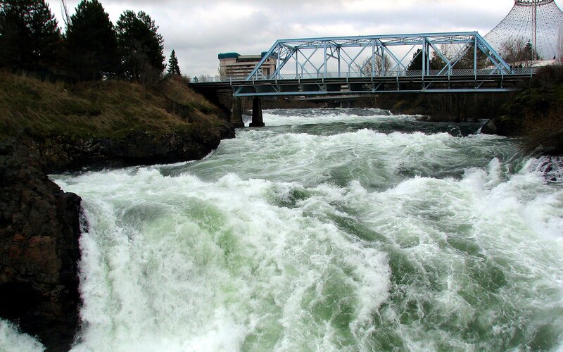 Rapid river under blue bridge