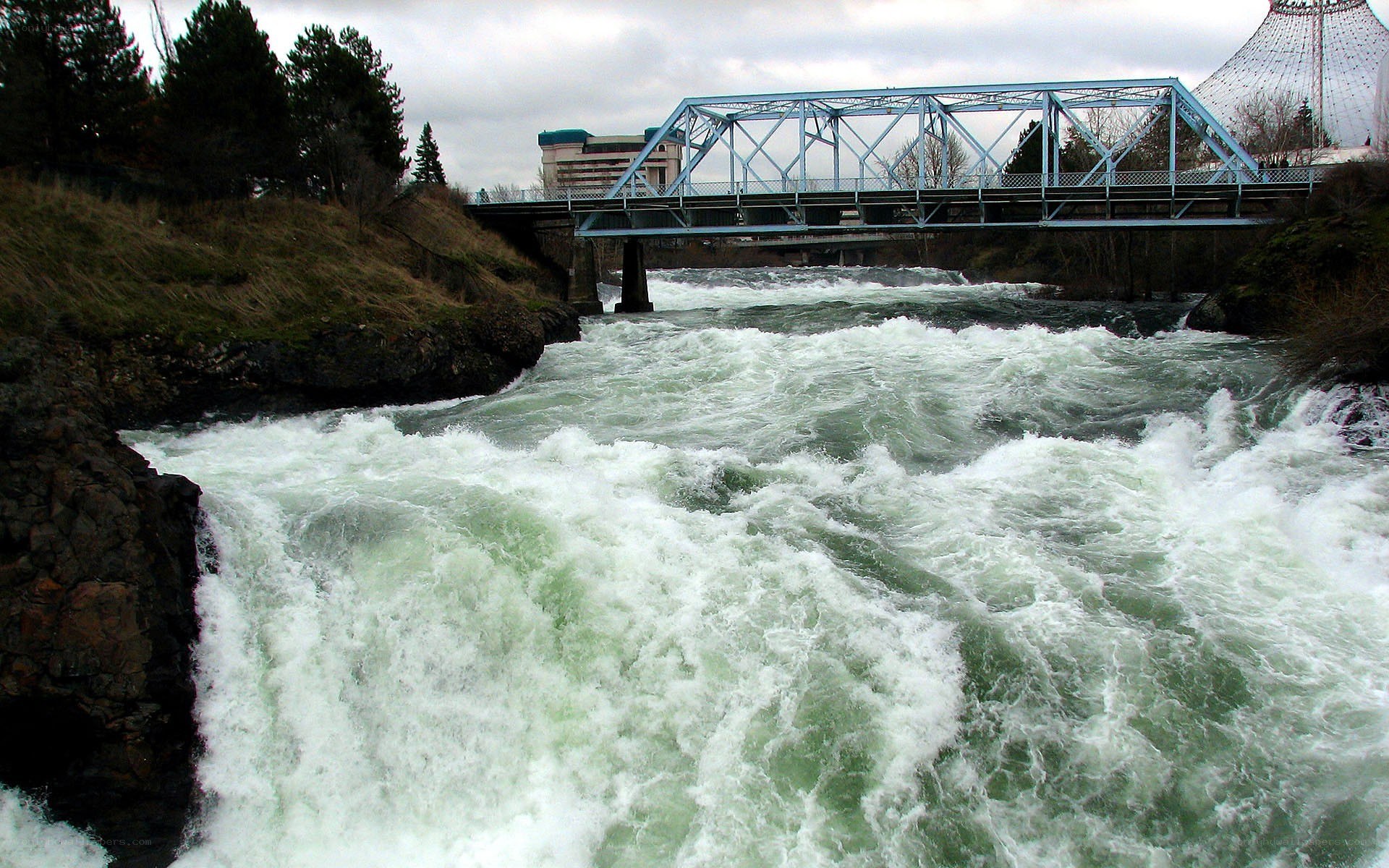Rapid river under blue bridge