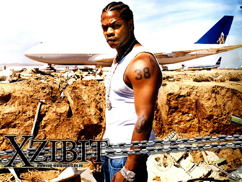 Rapper in front of plane wreckage