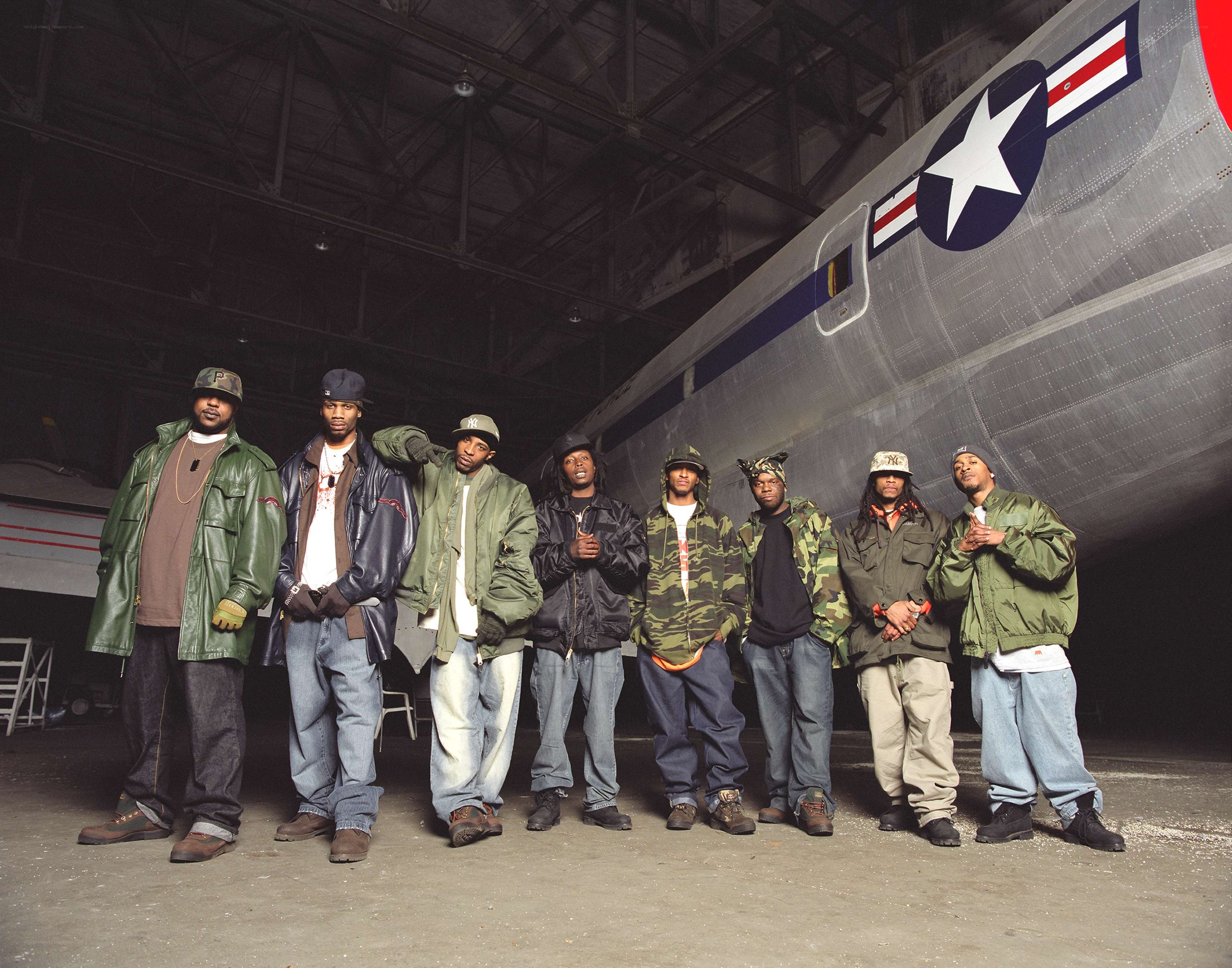 Rappers in hangar with airplane