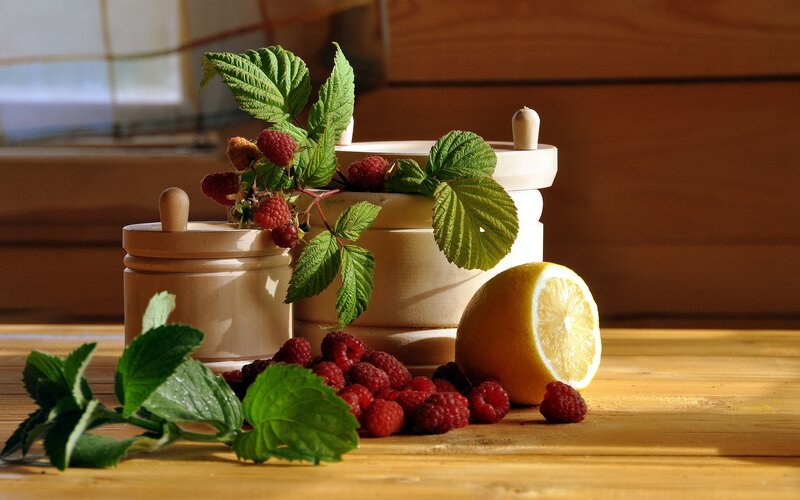 Raspberries and lemon on wood