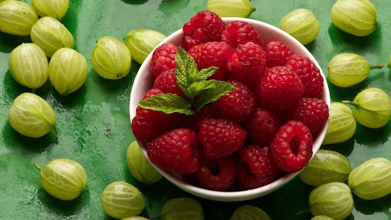 Raspberries in a Bowl — Red, Fresh, Photograph, Mint Leaves, Gooseberries, Green Surface