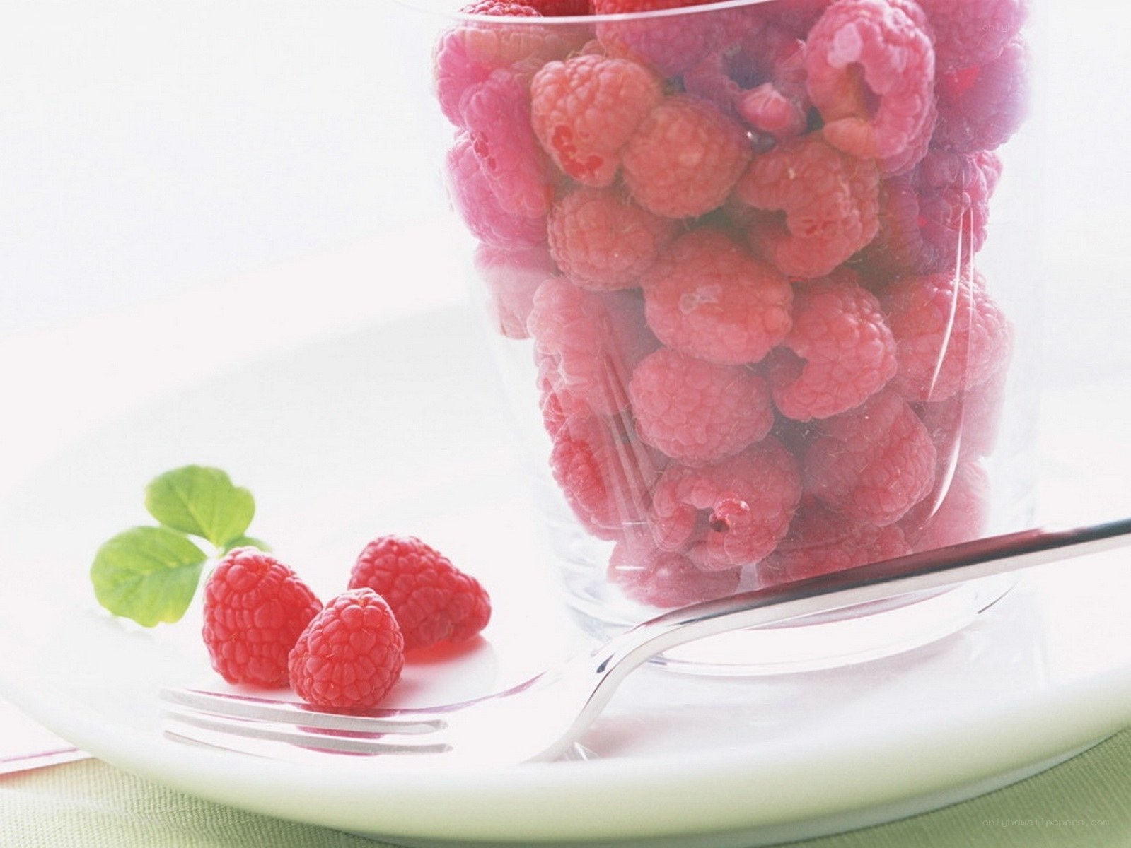 Raspberries in a glass cup