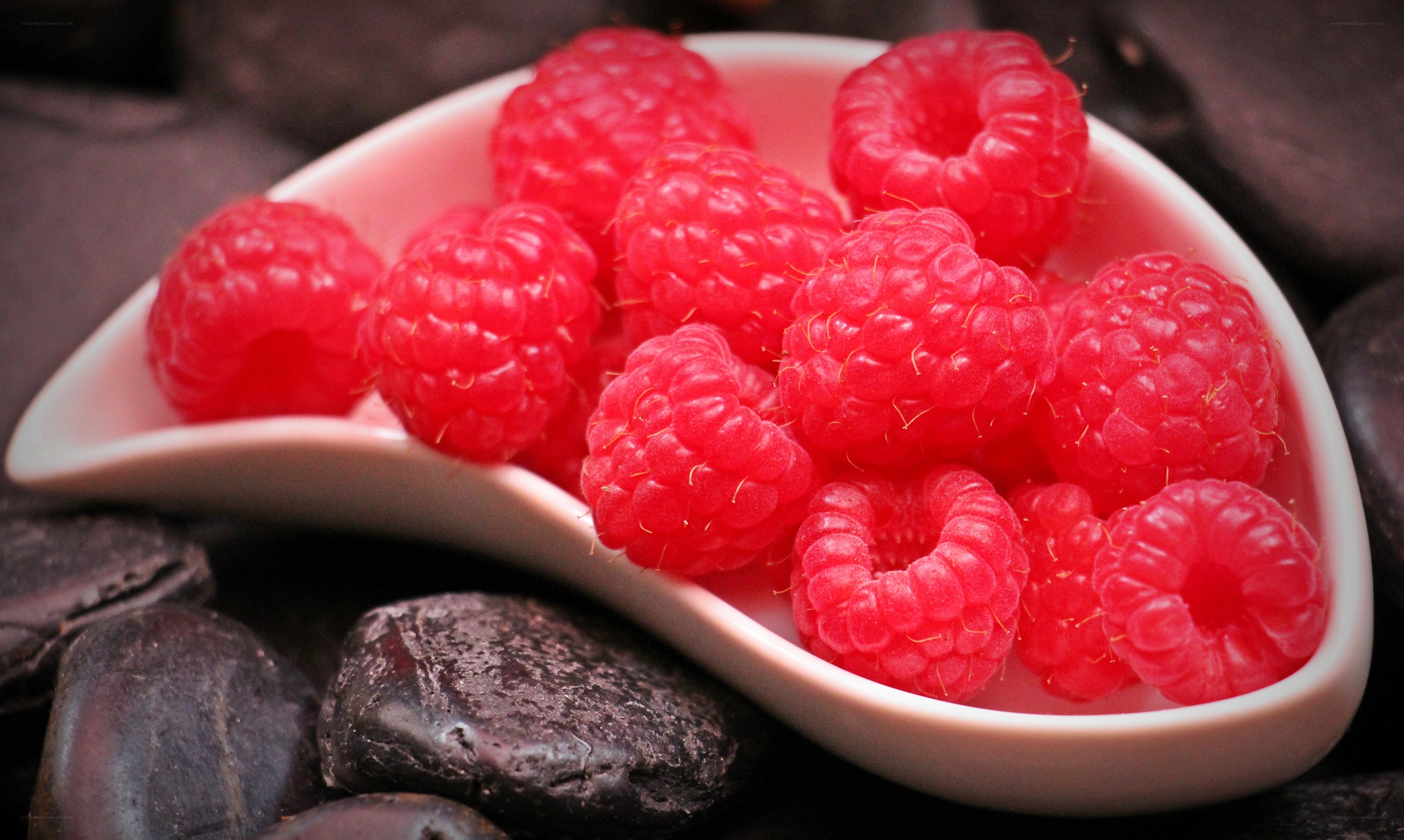 Raspberries in a white dish