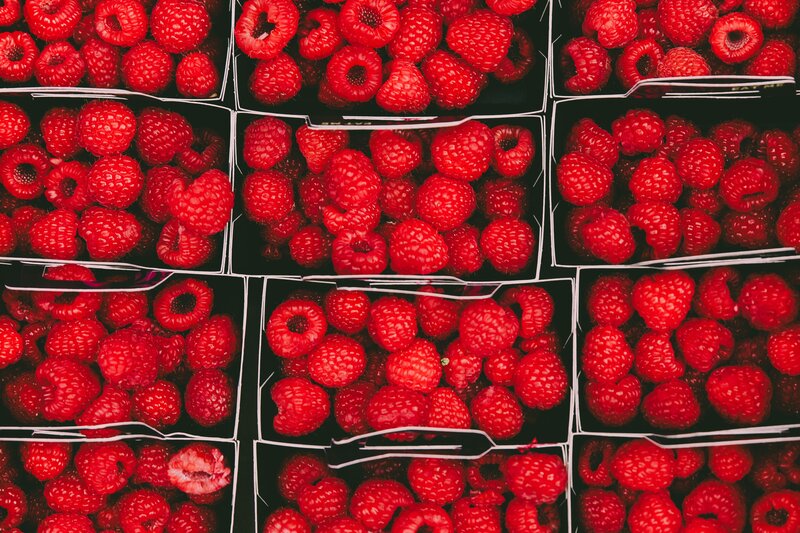 Raspberries in black containers