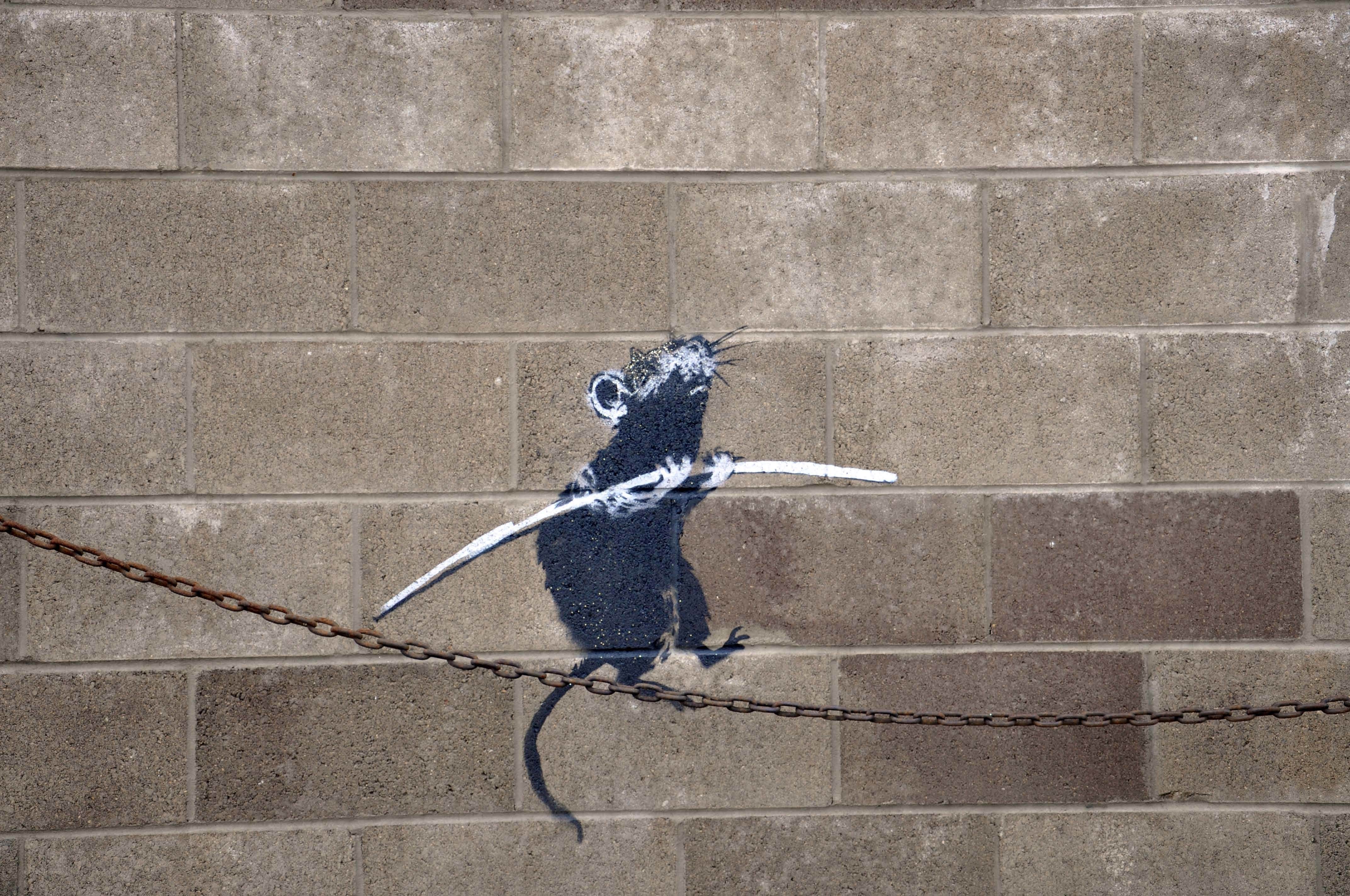 Rat graffiti on brick wall