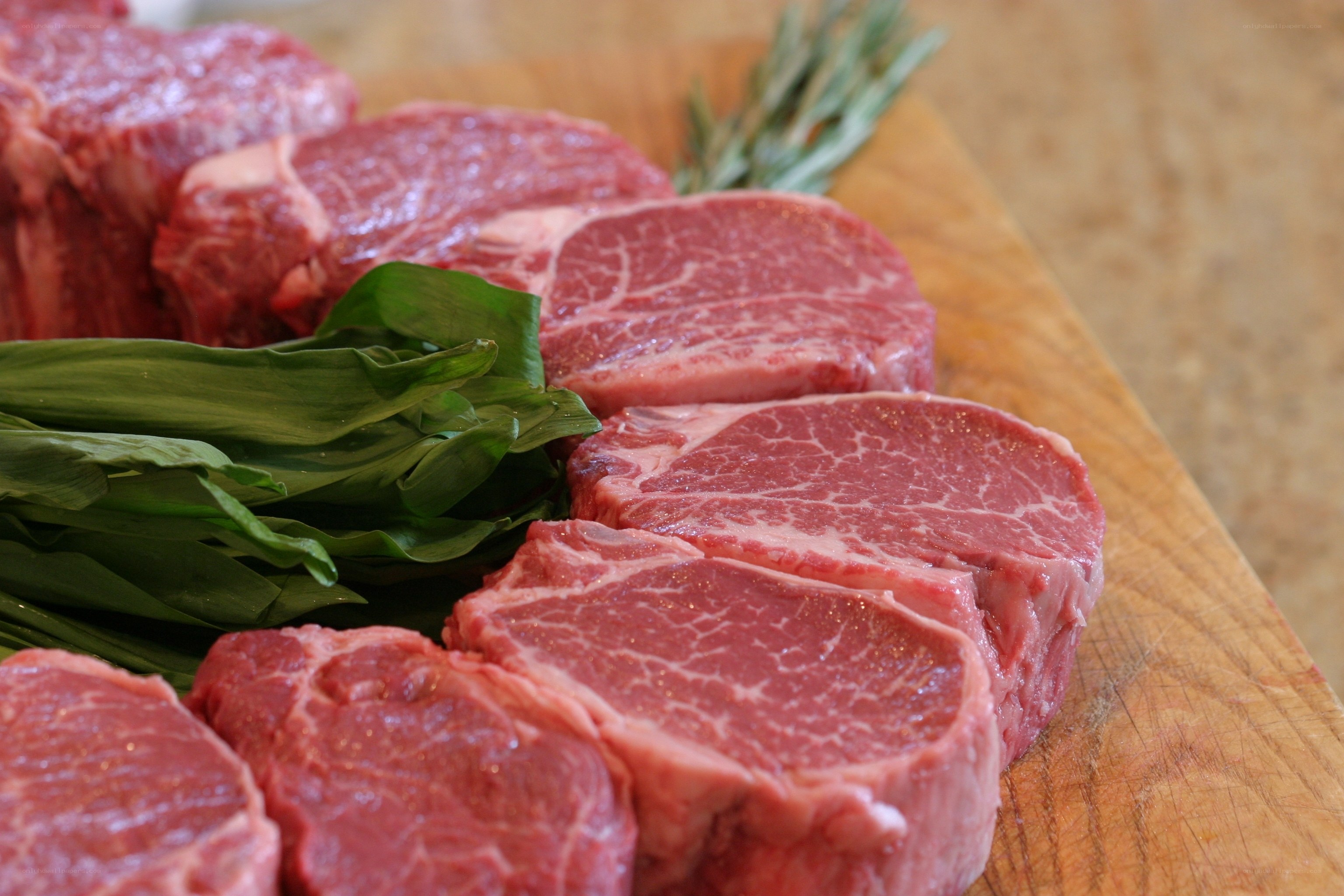Raw beef steaks on a cutting board