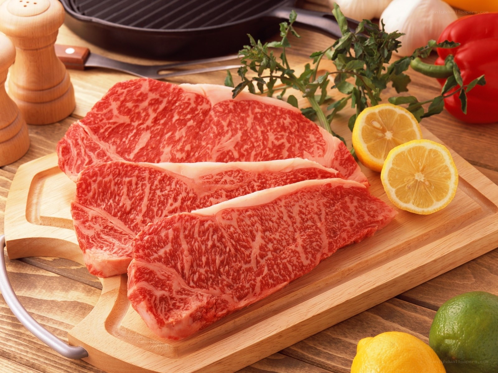 Raw beef steaks on cutting board
