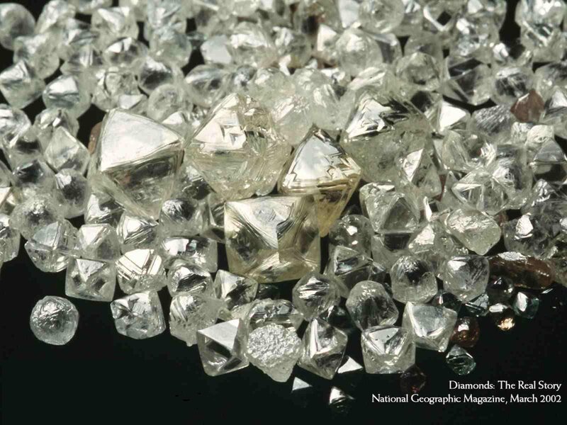 Raw diamonds on black background